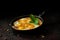 Egyptian Shakshuka, Fried Eggs in Tomato Sauce on black background.