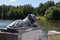 Egyptian sphinx stylized cast-iron sculpture of a lion near pond, Kuzminsky park, Moscow