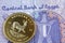 Egyptian twenty five piastres bank note with a gold krugerrand in macro