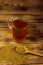 Egyptian yellow tea or Methi Dana drink and fenugreek seeds on wooden table