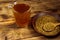 Egyptian yellow tea or Methi Dana drink and fenugreek seeds on wooden table