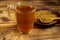 Egyptian yellow tea or Methi Dana drink and fenugreek seeds on wooden table