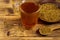 Egyptian yellow tea or Methi Dana drink and fenugreek seeds on wooden table