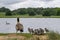 Egyption goose with babies looking at lake