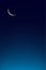 Eid al Adha Mubarak card,Crescent Moon on Blue Twilight Sky in Evening,Vertical Sunset after sundown,Dusk sky with copy space,