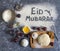Eid Mubarak - Islamic holiday welcome phrase ` happy holiday`, greeting reserved. Arabic cuisine background.