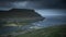 Eidi campsite on Eysturoy, a former football field in the Faroe Islands, at ocean coast with rain clouds