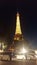 Eifel Tower at night with tour buses