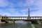 Eiffel Tower against blue sky with clouds and a bridge over Seine River. Paris France. April 2019