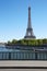 Eiffel tower and empty sidewalk bridge on Seine river