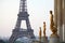 Eiffel tower and golden statues, morning in Paris, France