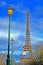 Eiffel tower and green street lamp line on blue cloudy sky, Europe travel diversity,