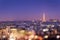 Eiffel tower illuminated at night with bokeh lights, Montmartre in the background, Paris