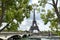 Eiffel tower and Jena bridge in a spring cloudy day, Paris, France.