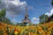 Eiffel tower in the landscape in Paris from the Champ de Mars with a colorful garden and flowers in the foreground