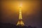Eiffel tower at misty night in Paris, France