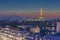 Eiffel tower over the crowded roofs