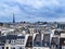 Eiffel tower over old Haussmann buildings roofs in Paris