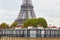 Eiffel tower over the Parisian roofs with attics and chimneys