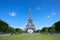 Eiffel Tower in Paris and empty green field of Mars meadow in a sunny day, clear blue sky