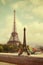 Eiffel Tower, Paris, France. Eiffel Tower souvenir in front of real tower. Retro filter effect.