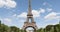 Eiffel Tower in Paris and green field of Mars meadow, people and tourists in a sunny summer day