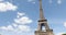 Eiffel Tower in Paris in a sunny summer day, lateral tilt view, blue sky in France