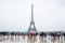 Eiffel tower in Paris with tourists and rain