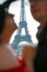 Eiffel tower between profiles of lovers.people are not in focus. symbol of Paris