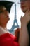 Eiffel tower between profiles of lovers.people are not in focus. symbol of Paris
