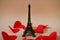 Eiffel tower and red hearts in a light pink background.