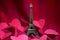 The Eiffel Tower and red hearts in a silk background.