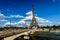 Eiffel Tower and Seine River with White Clouds in Background