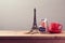 Eiffel Tower souvenir and money box on wooden table. Planning summer vacation, money budget trip