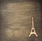 Eiffel tower toy at plywood background surface