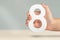 Eight in hand. A hand holds a white number 8 on a blurred background. Concept with number eight. Birthday 8 years