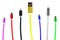 Eight multicolored usb cables, with connectors for micro and for iphone or ipad, stand upright, on a white background. Th