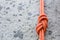 Eight rope knot on rocky background