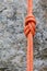 Eight rope knot on rocky background
