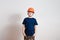 Eight-year-old boy in orange helmet working on white background