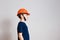 Eight-year-old boy in orange helmet working on white background