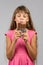 Eight-year-old girl with pleasure eats chocolate bar