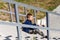 Eight-year-old schoolboy sits outside school with a book in his hand