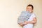 Eight-year-old smiling boy holding a lot of books. first-grader