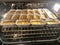 Eighteen loafs of pumpkin bread cooking in an oven