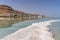 Ein Bokek Hotels against the backdrop of mountains and sky from the salt formations of the Dead Sea