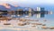 Ein Bokek, Israel. View of the coast and spa hotels at Dead Sea, salt formations in the foreground.