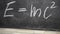 Einsteins formula written chalk on a slate