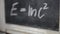 Einsteins formula written chalk on a slate