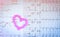 EKG or ECG Electrocardiogram graph report paper. EST Exercise Stress Test result and pink heart shape made from pills. Packa
